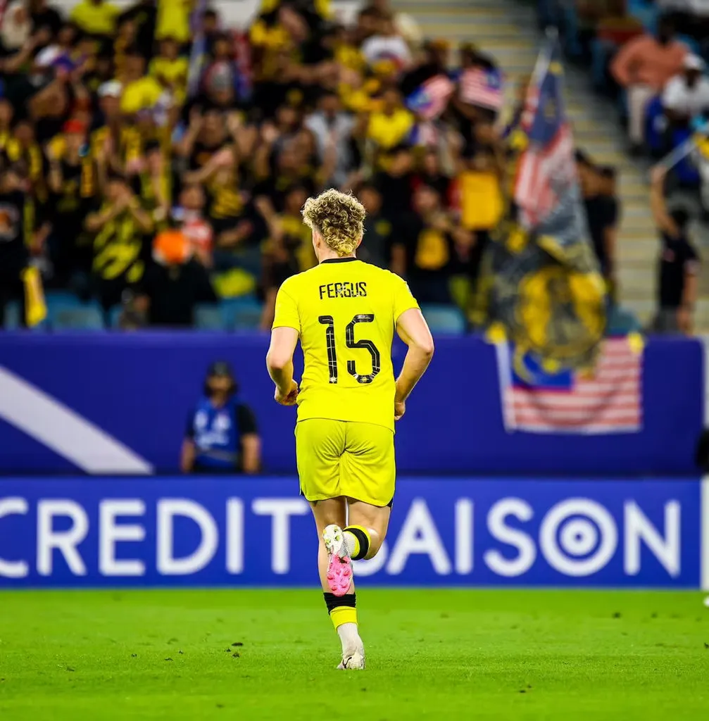 Fergus Tierney playing in the yellow shirt of the Malaysian national team