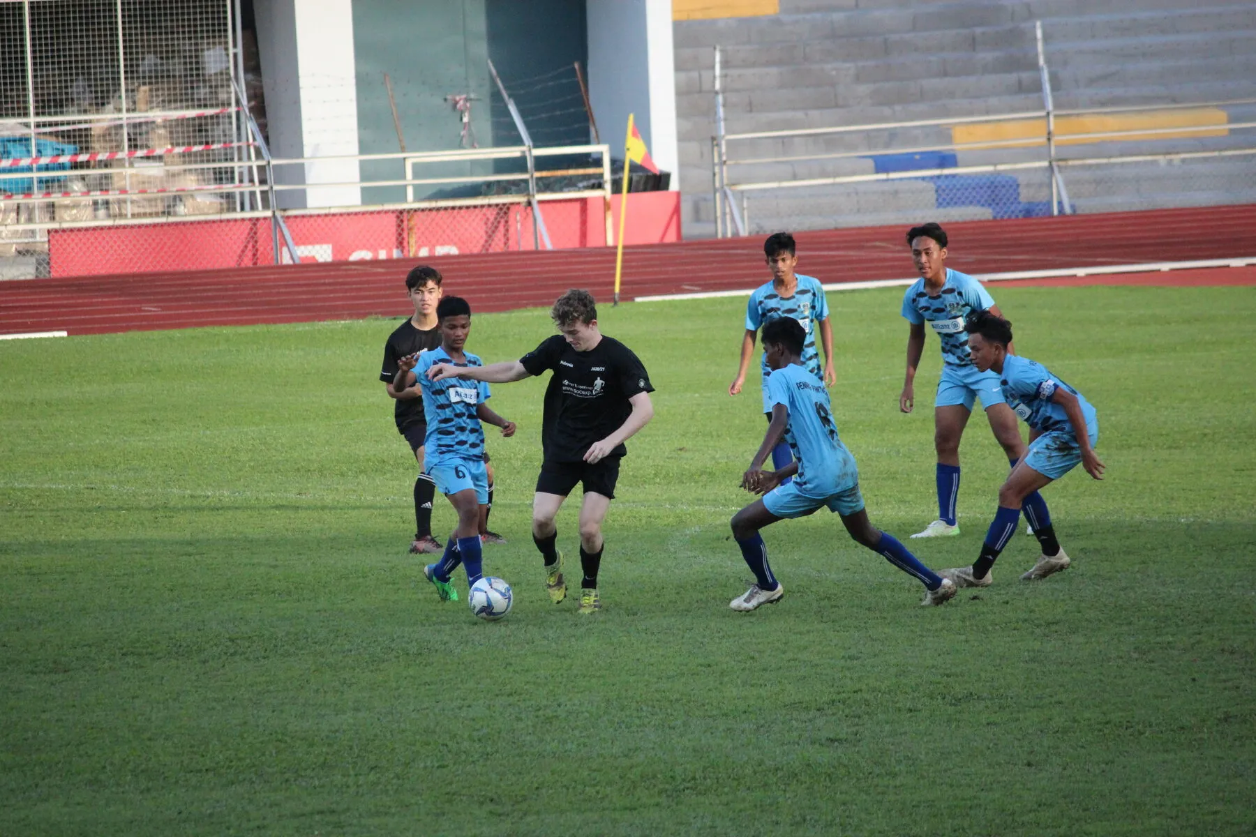 Youth players competing for the ball during an elite Soccer Experience coaching session in Asia