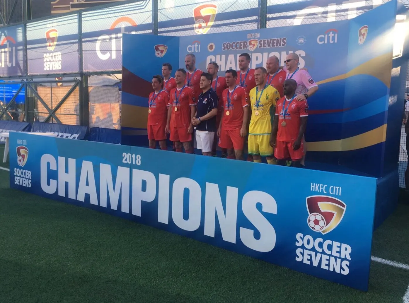 A veterans side lined up in front of the champions board at the HKFC Citi Soccer Sevens in 2018