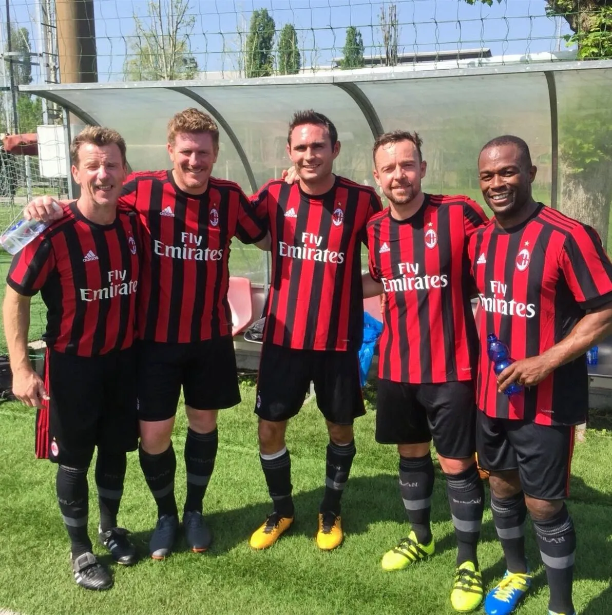 Five players in AC Milan kit on the pitch at the club’s academy in Milan